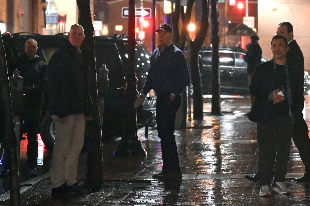 US President Joe Biden (centre) looks on after a car hit an SUV in the motorcade as he left his campaign headquarters in Wilmington, Delaware December 17, 2023. — AFP pic