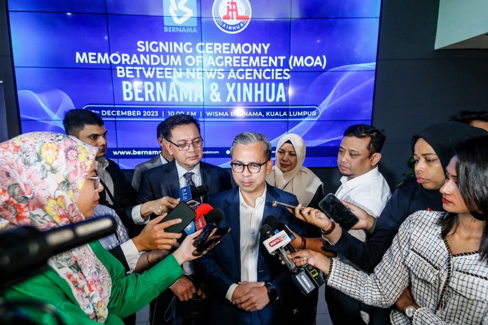 Communications Minister Fahmi Fadzil speaks to reporters at the MoA signing ceremony between Bernama and the China’s Xinhua News Agency at Wisma Bernama in Kuala Lumpur, December 18, 2023. — Picture by Hari Anggara 