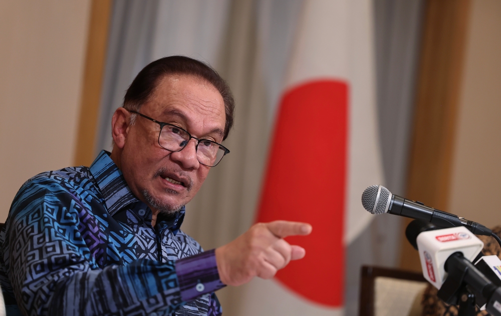 Prime Minister Datuk Seri Anwar Ibrahim speaking at a press conference with the Malaysian media about his working visit to Japan in Tokyo, December 18, 2023. — Bernama pic