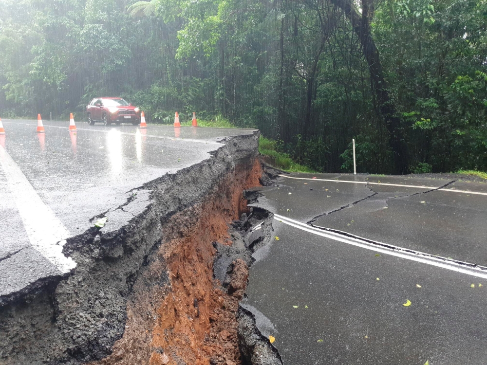 A supplied image obtained on Monday, December 18, 2023, shows a road split in half along the Palmerston Highway in far north Queensland, Australia following heavy rain and flooding from ex-tropical cyclone Jasper. ― AAP Image/Supplied by Ergon Energy via Reuters