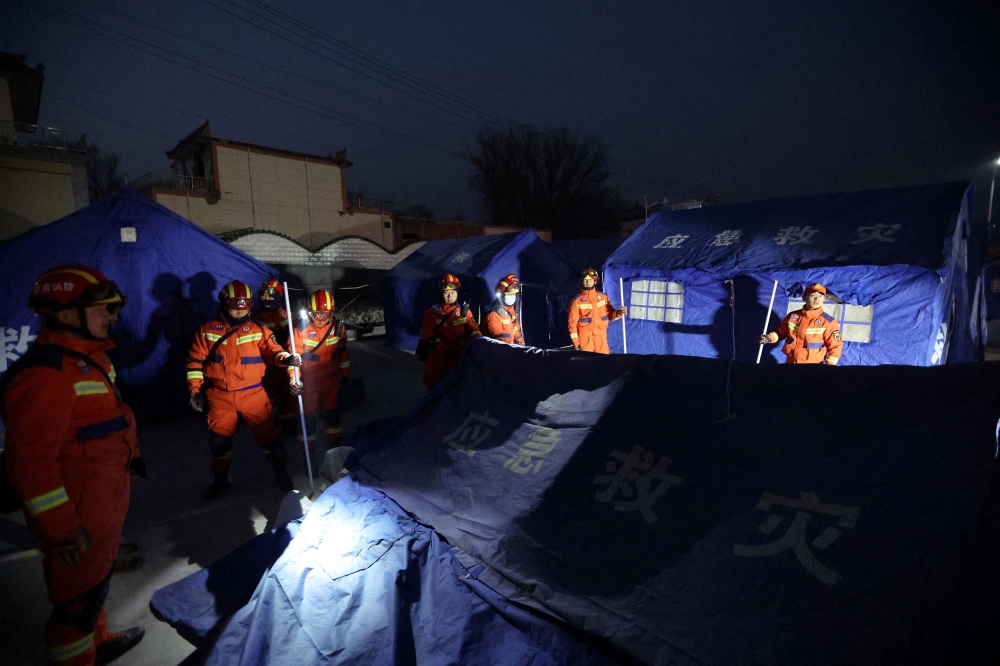 Rescue workers set up emergency tents at Kangdiao village following the earthquake in Jishishan county, Gansu province, China December 19, 2023. ― China Daily via Reuters