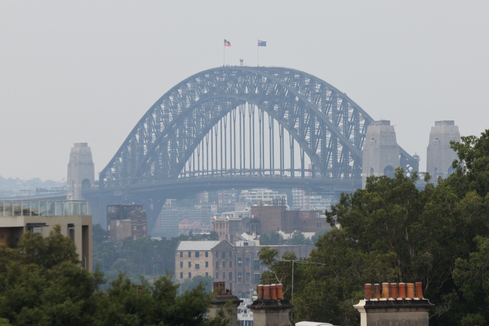 A view of the Sydney Harbour Bridge shrouded in smog from nearby bushfires in Sydney, Australia December 19, 2023. ― Reuters pic