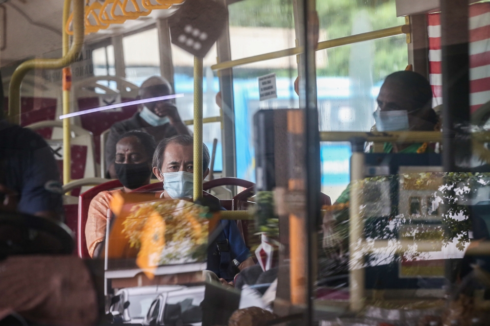 People wear masks while using public transport at Medan Kidd Bus Station Ipoh, Perak, December 19, 2023. — Picture by Farhan Najib
