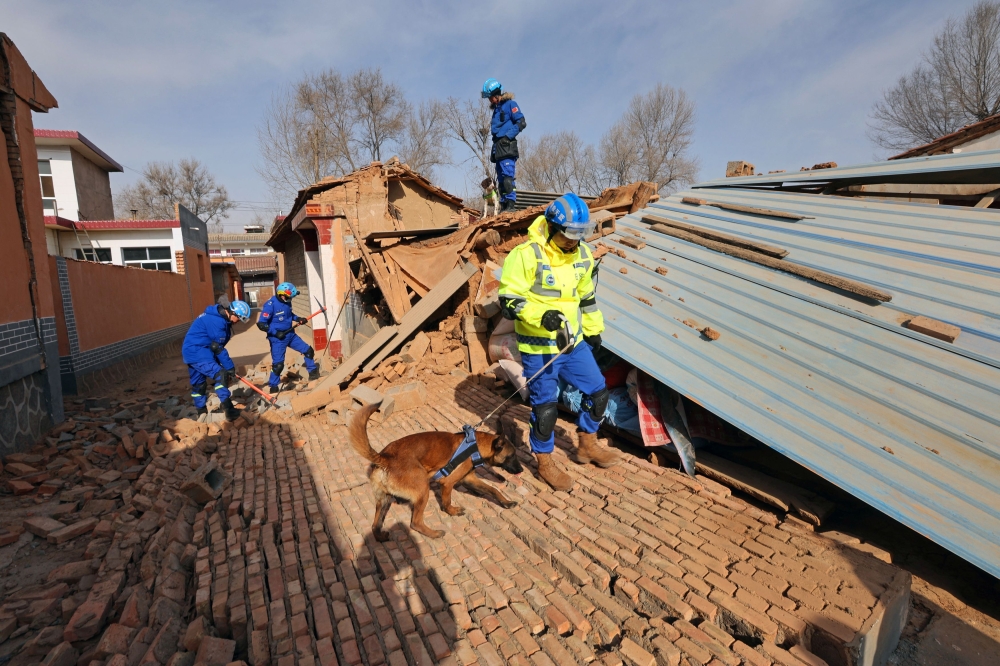 Members of the Blue Sky Rescue team work with rescue dogs as they search through the rubble at Hanshanjia village following the earthquake in Jishishan county, Gansu province, China December 19, 2023. ― China Daily via Reuters