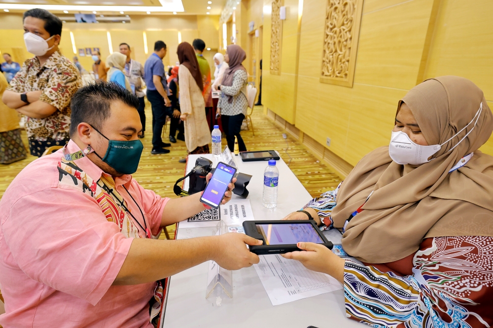 Staff from the Communications Ministry register their National Digital Identity or MyDigital ID with Mimos in Putrajaya, December 21, 2023. — Bernama pic 
