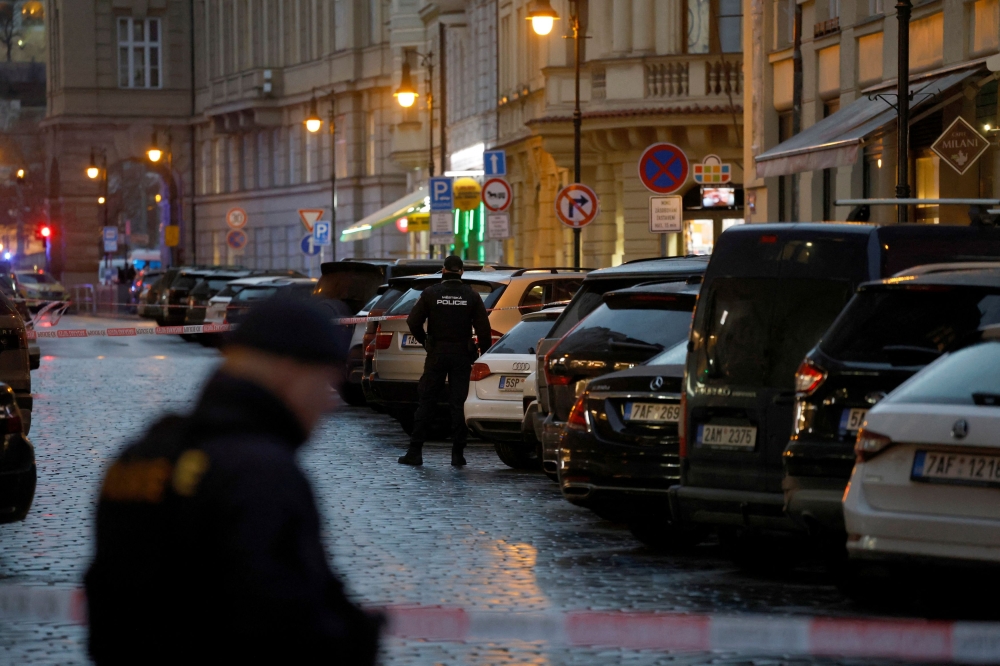 Police officers secure the area following the shooting at one of the buildings of Charles University in Prague, Czech Republic December 21, 2023. ― Reuters pic