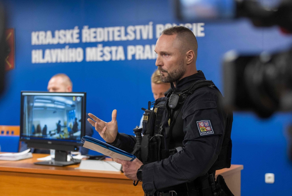 A policeman addresses a press conference on December 22, 2023 in Prague to inform about a deadly mass shooting at a university the day before. — AFP pic