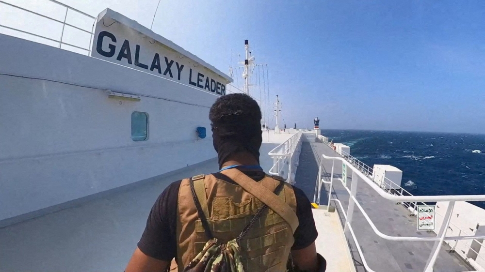 A Houthi fighter stands on the Galaxy Leader cargo ship in the Red Sea in this photo released November 20, 2023. ― Houthi Military Media/Handout via Reuters