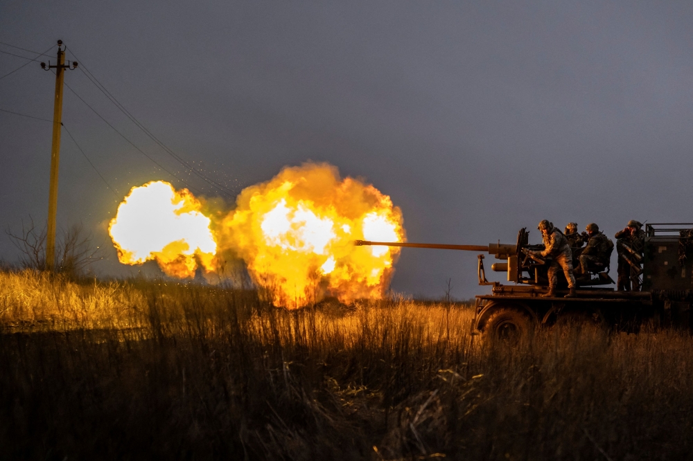 Service members of Ukrainian Joint Assault Brigade Fury fire a S60 cannon towards Russian troops near the front-line town of Bakhmut, amid Russia's attack on Ukraine, in Donetsk region, Ukraine December 21, 2023. ― Reuters pic