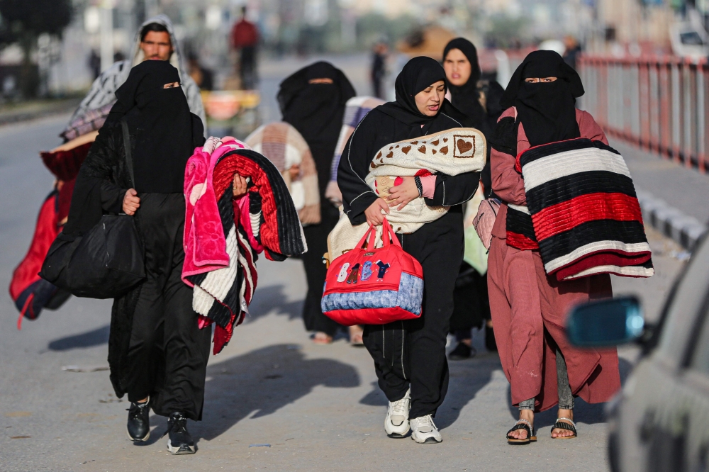 Residents of the refugee camp of Bureij arrive in Deir al-Balah in the central Gaza Strip following an evacuation order, on December 22, 2023, amid the ongoing conflict between Israel and the Palestinian militant group Hamas. ― AFP pic
