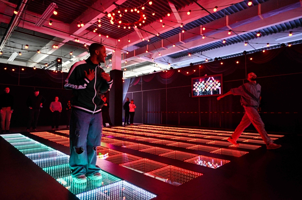 Visitors participate in  the 'Memory Steps' game, inspired by the Glass Bridge game at 'Squid Game: The Trials'. — AFP pic