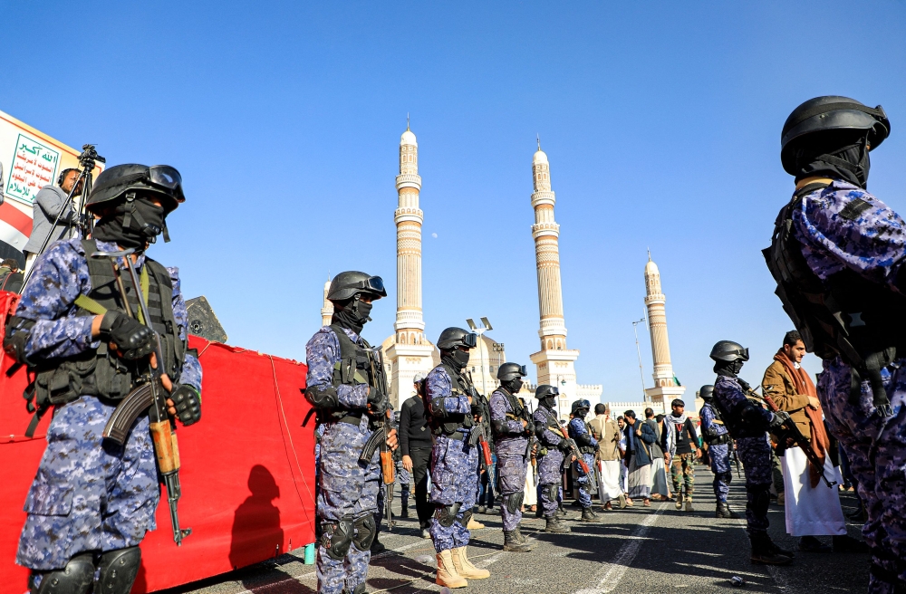 Yemen’s Huthi-affiliated security forces stand guard during a march in solidarity with the people of Gaza in the capital Sanaa. — AFP pic