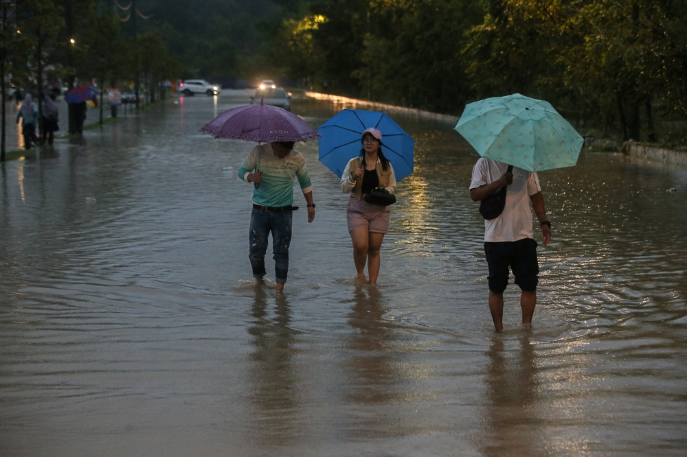 Negeri Sembilan became the latest state to be hit by floods, while more people were evacuated to relief centres in Kelantan and Terengganu. ― Picture by Farhan Najib