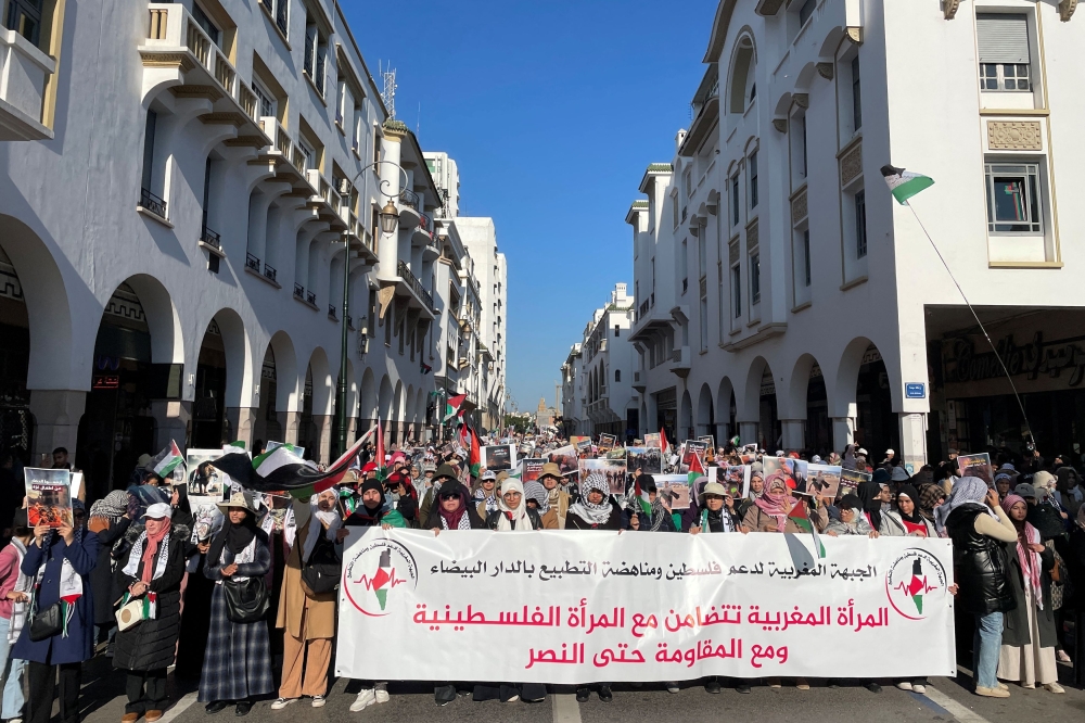 Protesters hold a banner, at a demonstration calling for an end to Morocco's ties with Israel, amid the ongoing conflict between Israel and Palestinian Islamist group Hamas, in Rabat, Morocco December 24, 2023. — Reuters pic