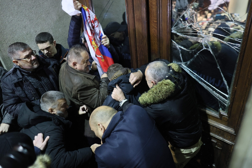 Serbian opposition demonstrators broke windows as they tried to storm Belgrade city hall yesterday evening during protests over alleged election fraud, with police pushing them back with pepper spray, according to an AFP reporter on the scene. — AFP pic