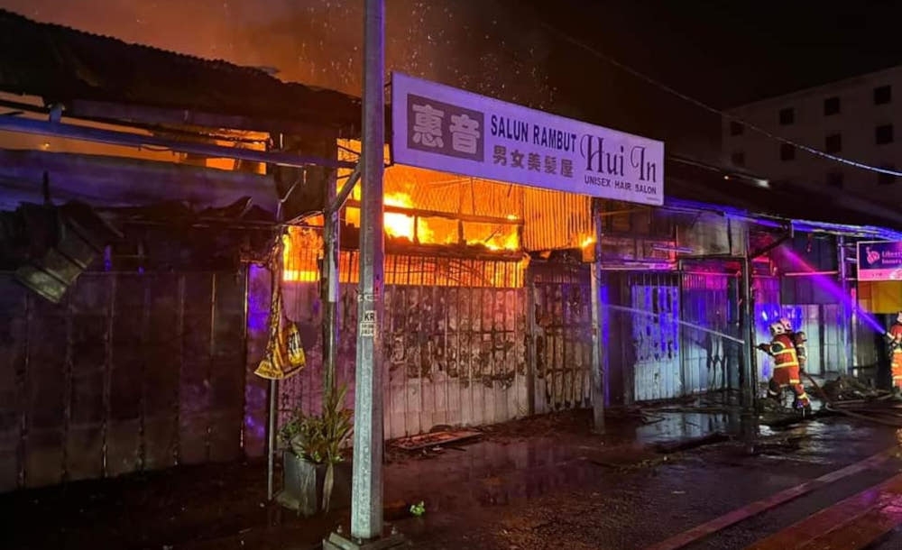Firemen attempt to put out the fire on Jalan Kuala Ketil, at Pekan Lama Sungai Petani, Kedah, December 25, 2023. — Picture from social media