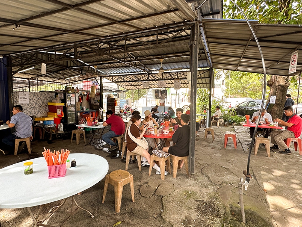 The shack sits on a large space with tables and chairs placed far apart