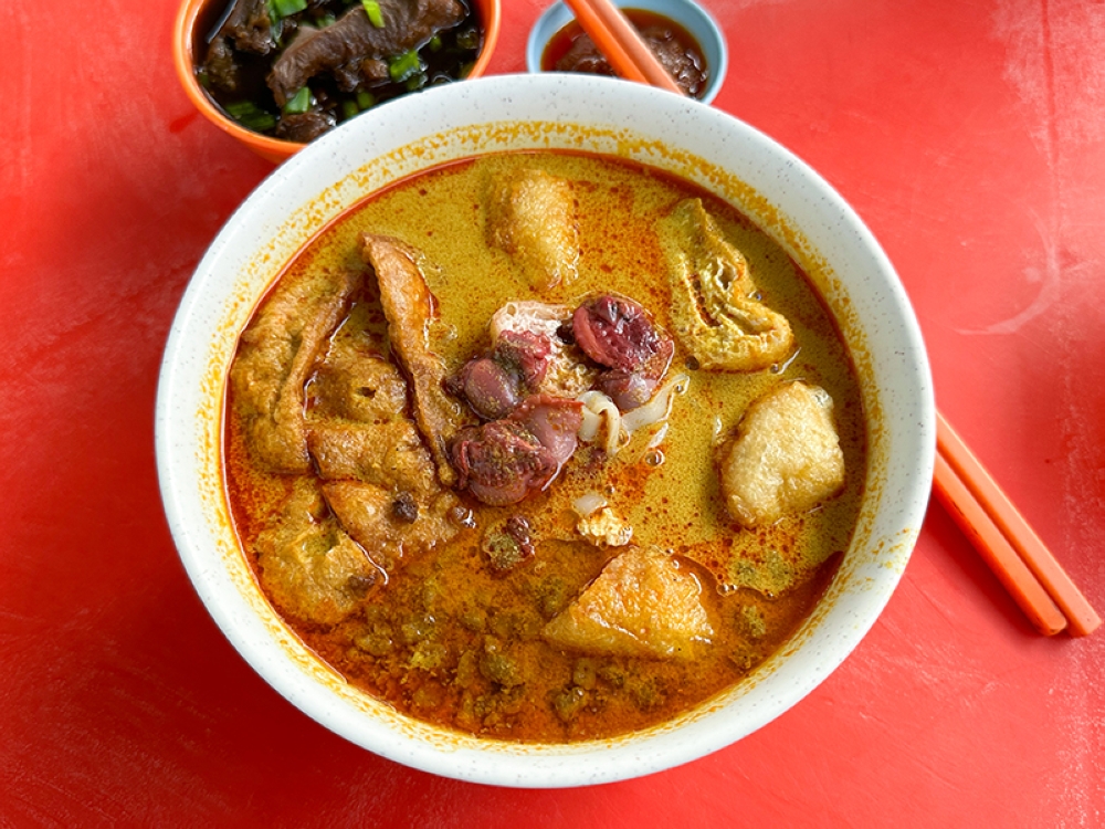 The curry noodles is mildly spicy and creamy served with cockles, beancurd puff and minced meat