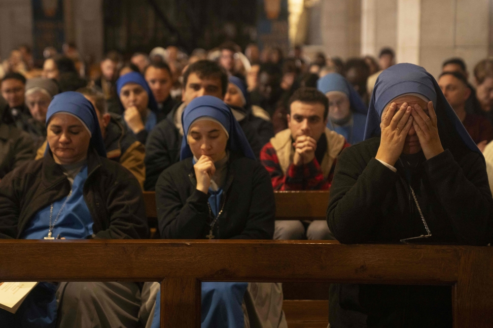 This picture taken on December 24, 2023 shows worshippers attending the Christmas midnight Mass at the Church of the Nativity compound in the biblical city of Bethlehem in the occupied West Bank. — AFP pool pic