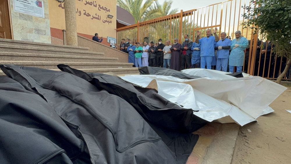 Medical staff react next to the bodies of Palestinians killed in Israeli strikes, amid the ongoing conflict between Israel and Palestinian Islamist group Hamas, at Nasser hospital in Khan Younis, in the southern Gaza Strip, December 20, 2023. — AFP pic