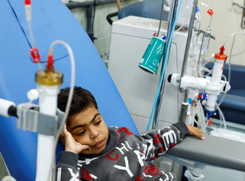 Palestinian boy Naseem Mohra, a 10-year-old kidney patient from northern Gaza who fled south with his family when Israel began the ground assault against Hamas and was separated from his mother, undergoes kidney dialysis at a hospital in Rafah in the southern Gaza Strip December 24, 2023. — Reuters pic
