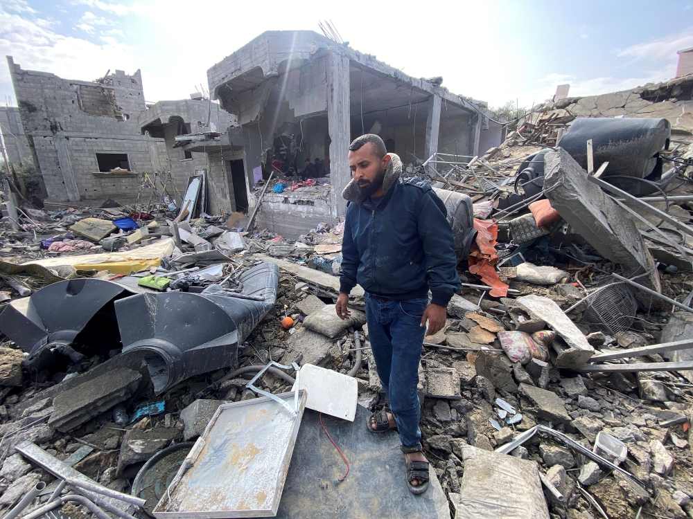 Palestinian man Ibrahim Al-Haj Youssef, who lost four of his children and his wife in an Israeli air strike, stands amidst debris, amid the ongoing conflict between Israel and Hamas, at the Maghazi camp, in the central Gaza Strip, December 25, 2023. — Reuters pic