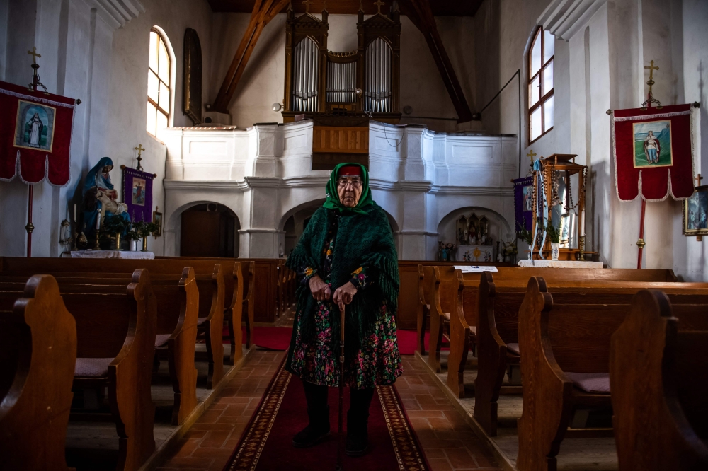 Auntie Ilonka, stands after she rang the bell in the catholic church in Tereny. — AFP pic