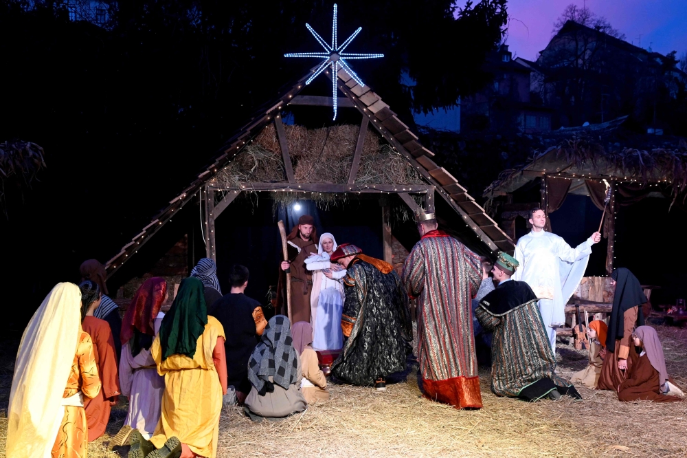Actors dressed in costumes play the birth of Jesus Christ for spectators in the centre of Zagreb on December 25, 2023. — AFP pic