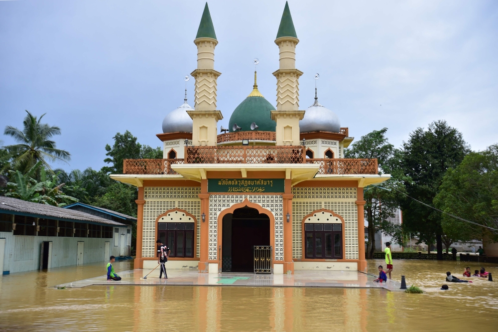 A mosque is seen surrounded by floodwaters following heavy rain in Thailand's southern province of Narathiwat on December 26, 2023. — AFP pic