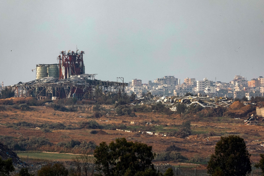 A picture taken from southern Israel on the border with the Gaza Strip on December 27, 2023, shows destroyed buildings in northern Gaza following Israeli bombardment amid ongoing battles between Israel and the Palestinian militant group Hamas. — AFP pic