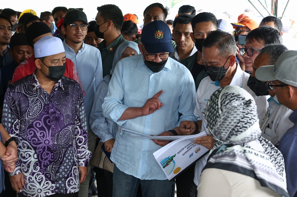 Prime Minister Datuk Seri Anwar Ibrahim is briefed on the latest developments of the Sungai Golok integrated river basin development project (PLSB) near Lubok Jong Bridge, Pasir Mas, December 28, 2023. — Bernama pic 
