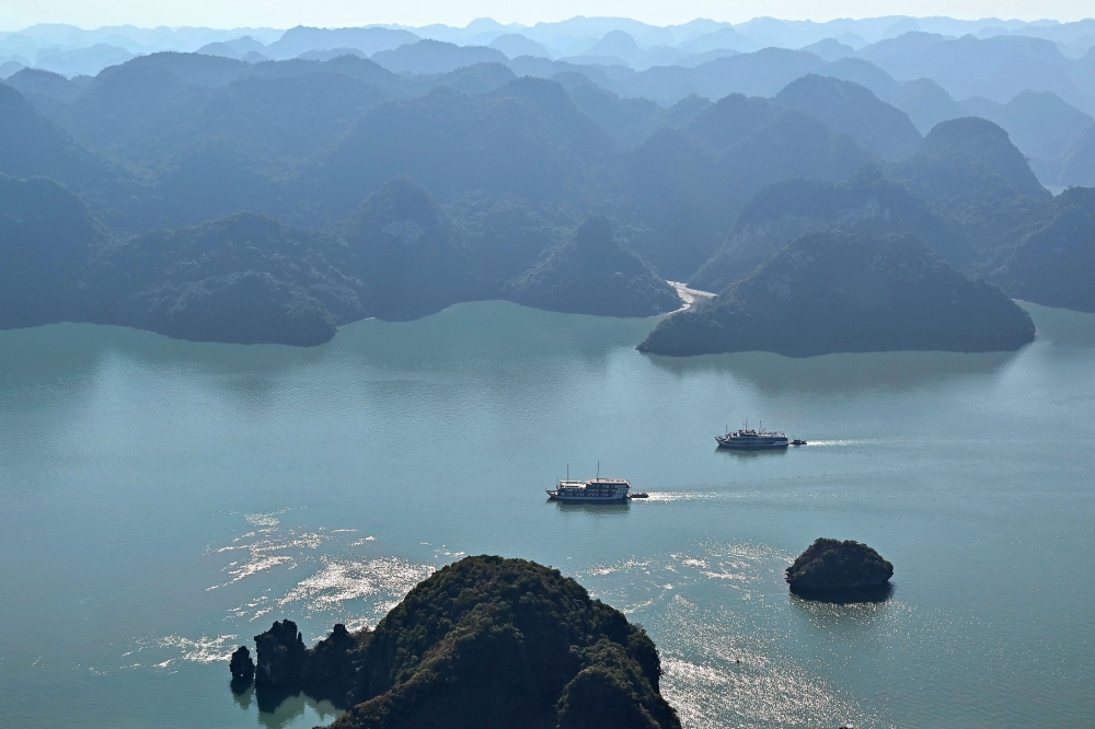 This aerial photo taken from a seaplane shows tourist boats sailing on the waters of Ha Long Bay in Vietnam’s north-eastern province of Quang Ninh on December 28, 2023. Vietnam’s Ha Long Bay is losing its famous turquoise hue as pollution and over-development threatens wildlife and its picture-perfect image. — AFP pic 