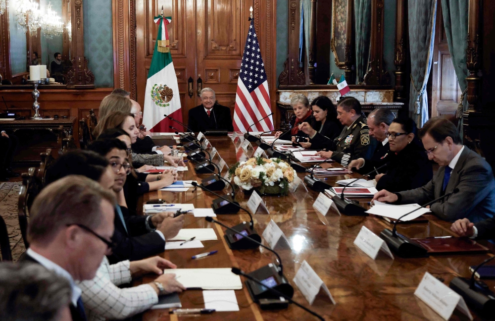 Mexican President Andres Manuel Lopez Obrador (centre) attends a meeting with US Secretary of State Antony Blinken, US Secretary of Homeland Security Alejandro Mayorkas, and US Ambassador Ken Salasar (out of frame), in addition to other officials, at the Palacio Nacional in Mexico City December 27, 2023. — AFP pic