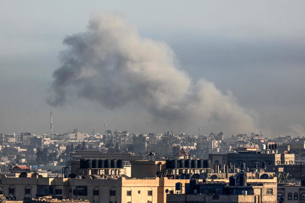 AFP TV footage showed smoke billowing over Rafah, near Egypt, following fresh strikes early today. — AFP pic