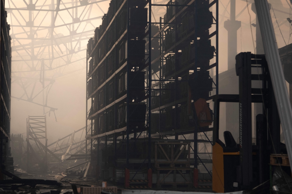 This photograph taken on December 29, 2023 shows a damaged warehouse after being extinguished by firefighters in the centre of Kyiv, amid the Russian invasion of Ukraine. Russia launched drone and missile strikes across Ukraine on December 29, 2023, killing at least 12 people and wounding over 70 in one of the biggest air attacks of the war. — AFP pic