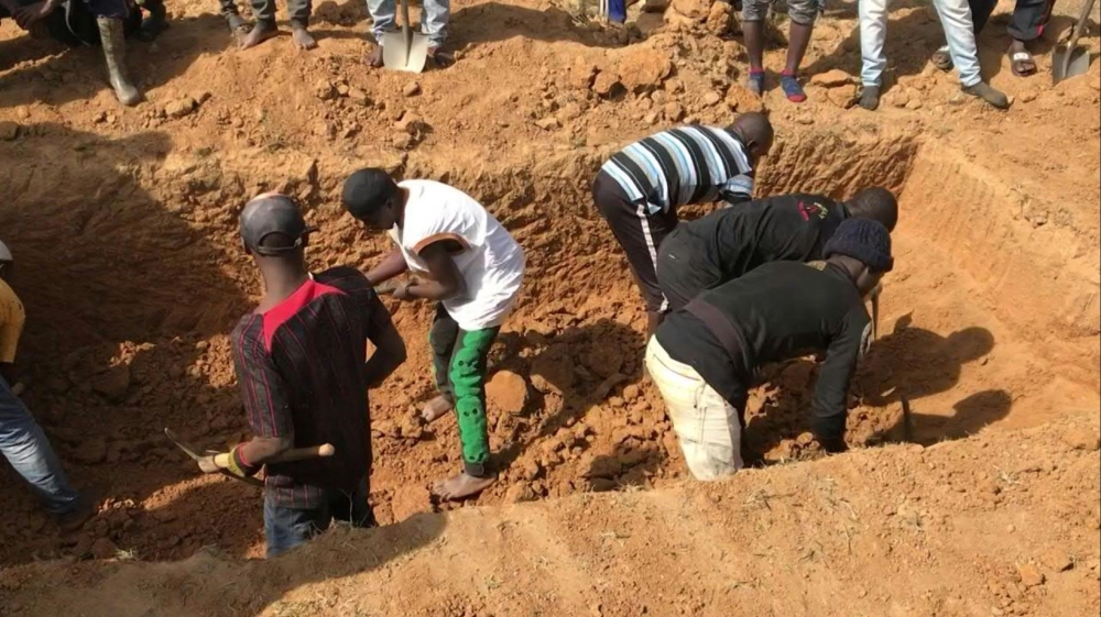 This image grab made from an AFPTV video taken in Maiyanga village, in Bokkos local government, on December 27, 2023 shows families burying in a mass grave their relatives killed in deadly attacks conducted by armed groups in Nigeria's central Plateau State. — AFP pic