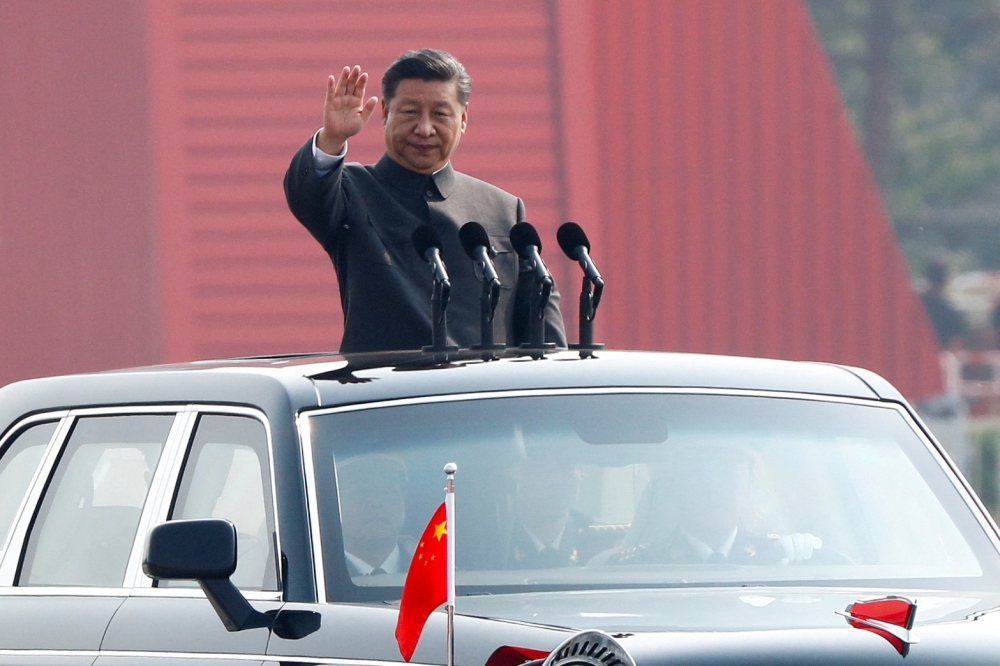 File photo of Chinese President Xi Jinping waving from a vehicle as he reviews the troops at a military parade marking the 70th founding anniversary of People's Republic of China, China October 1, 2019. — Reuters pic