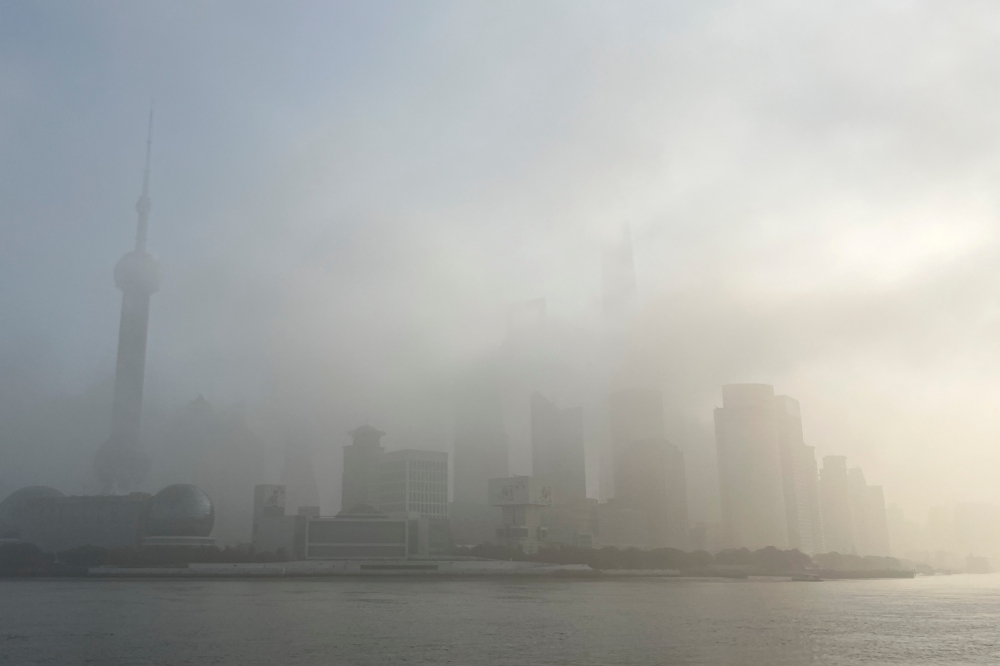 The Oriental Pearl Tower and other buildings in Lujiazui financial district across the Huangpu river are seen shrouded in fog amid a red alert for heavy fog in Shanghai, China December 29, 2023. — Reuters pic