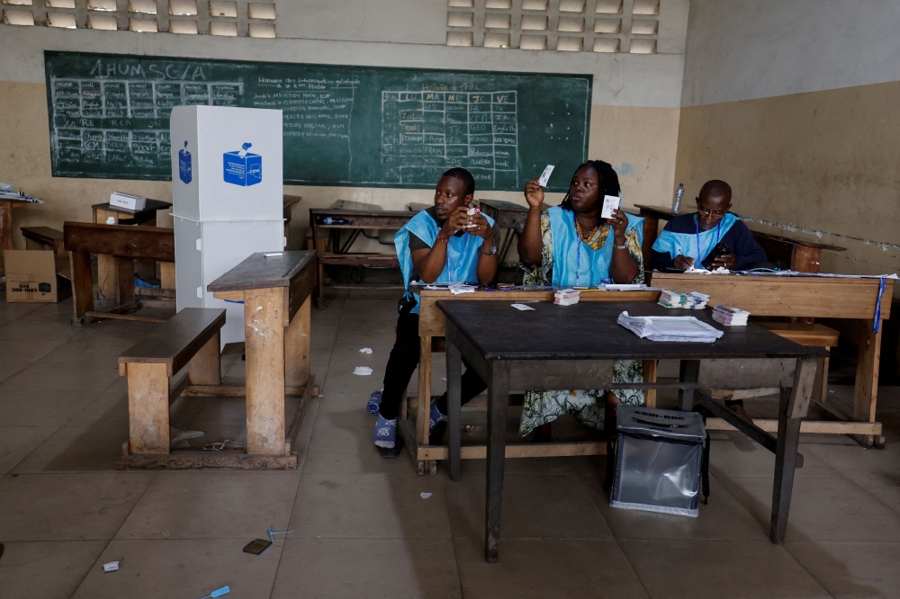 Agents of Congo's National Independent Electoral Commission (CENI) count casted ballot during the parliamentary and presidential election at a polling station in Kinshasa, the Democratic Republic of Congo December 21, 2023. — Reuters pic