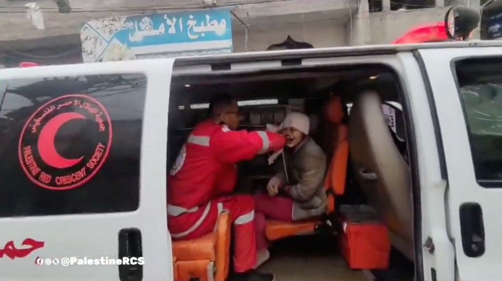A member of the Palestine Red Crescent Society treats a Palestinian child wounded in an Israeli strike, in a location given as Khan Younis, Gaza in this screengrab obtained from a video released on December 30, 2023. — Palestine Red Crescent Society handout via Reuters