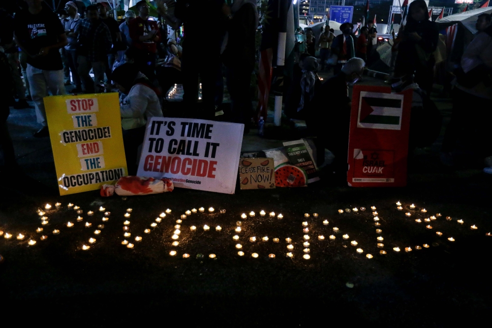 Placards calling for an end to the Israeli occupation and genocide of Palestinians. — Picture by Sayuti Zainudin