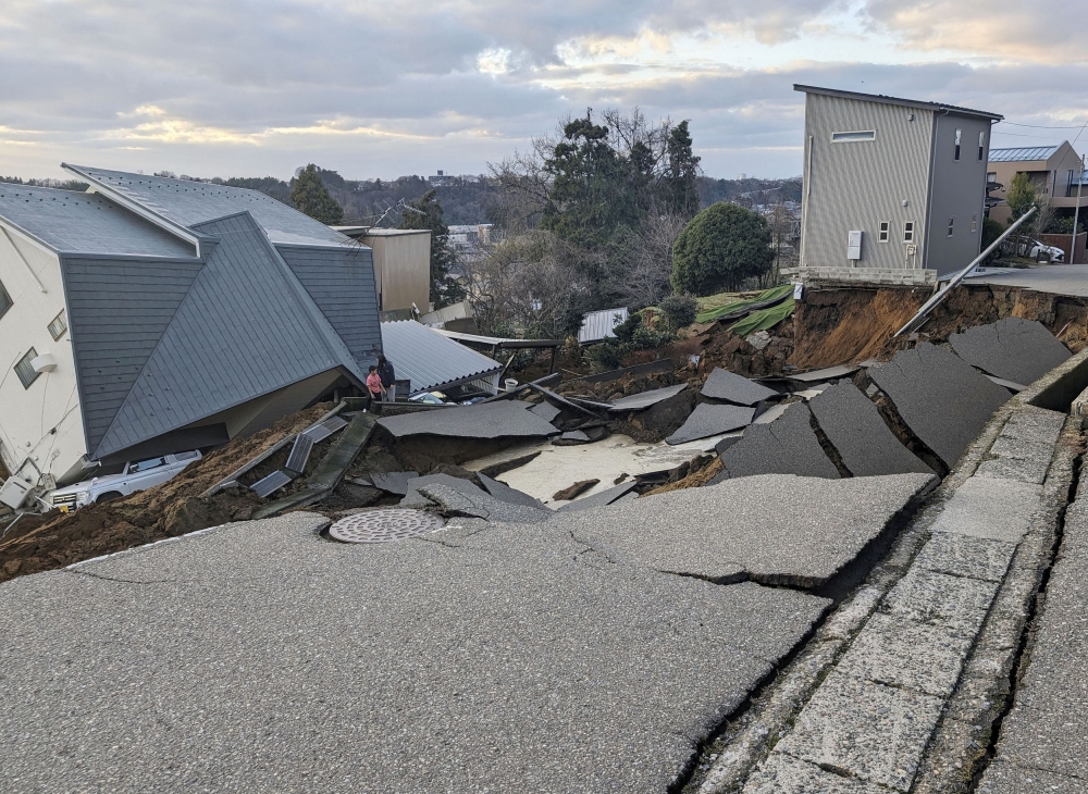 A view of a collapsed road and houses because of an earthquake in Wajima, Ishikawa prefecture, Japan January 2, 2024, in this photo released by Kyodo. ― Kyodo via Reuters