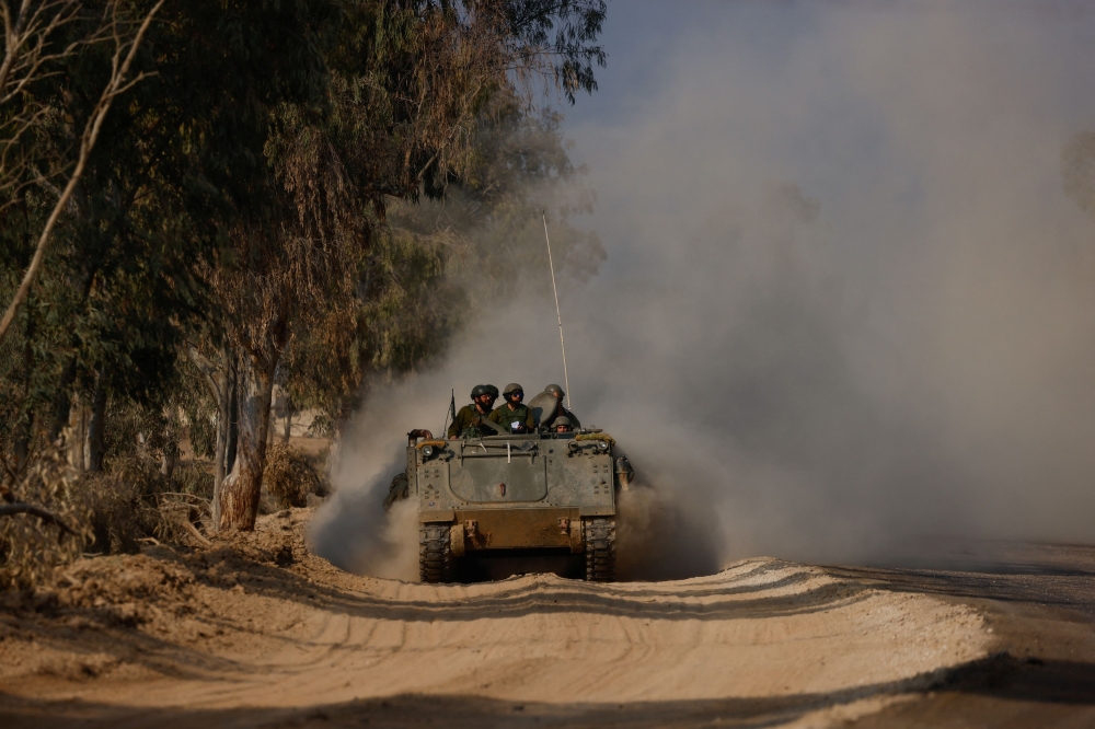 An Israeli armoured personnel carrier (APC) manoeuvres along the border with central Gaza, amid the ongoing conflict between Israel and the Palestinian group Hamas, in southern Israel, January 1, 2024. ― Reuters pic