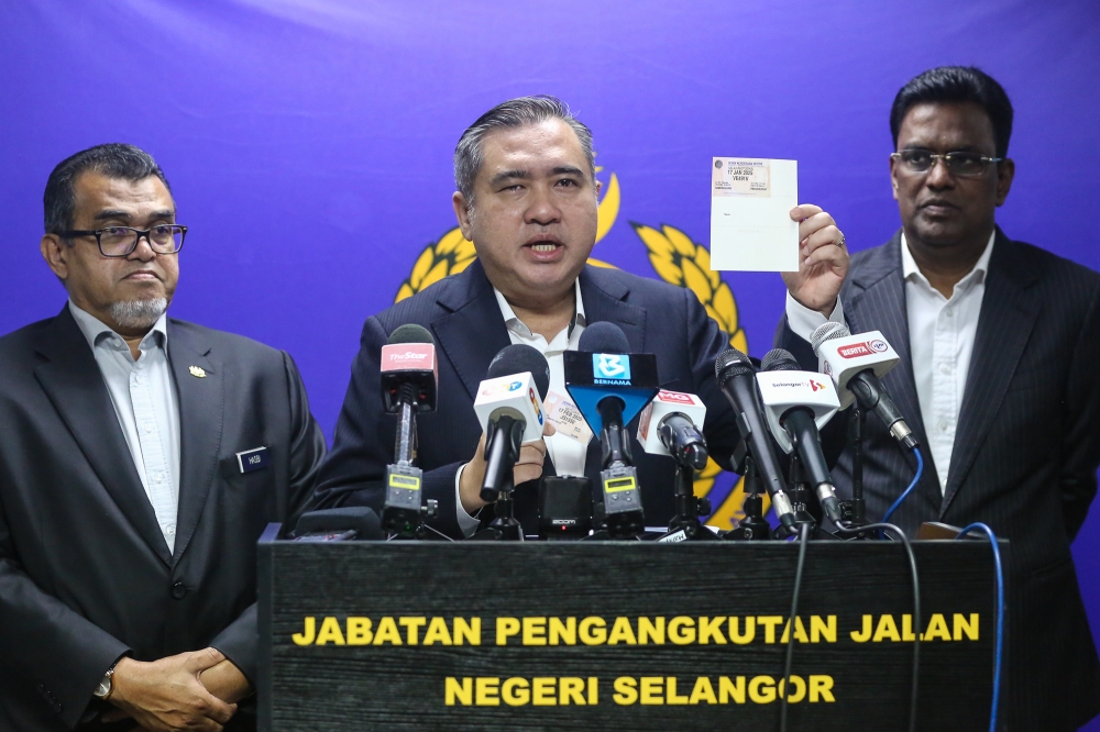 Transport Minister Anthony Loke (centre) speaks during a press conference at the Selangor headquarters of the Road Transport Department in Shah Alam January 2, 2024. — Picture by Yusof Mat Isa