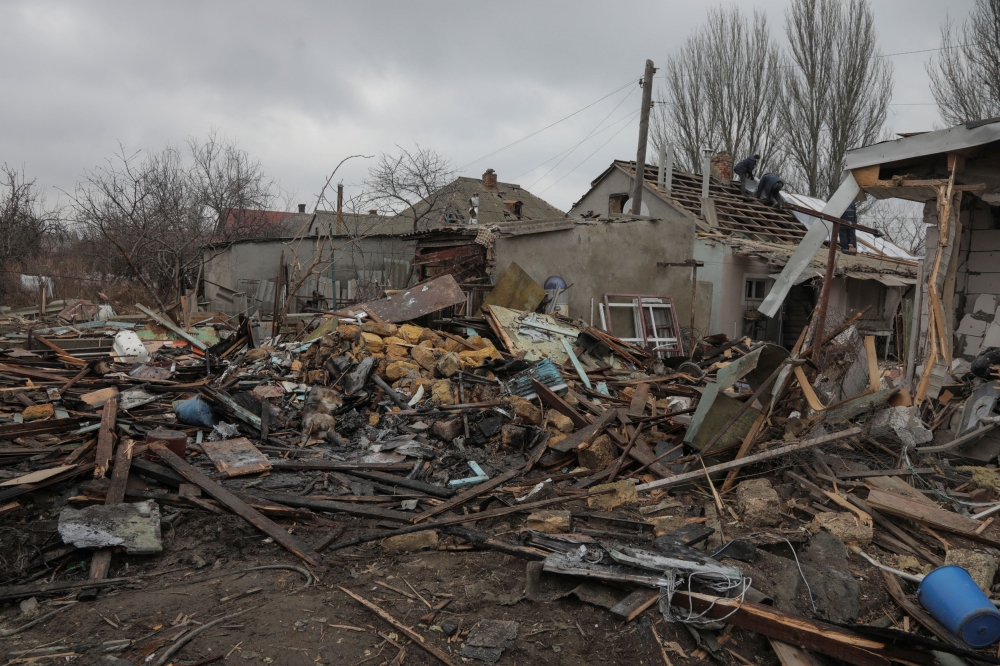 Municipal employees work at a compound of residential houses heavily damaged during a Russian drone strike, amid Russia's attack on Ukraine, in Odesa, Ukraine January 1, 2024. ― Reuters pic