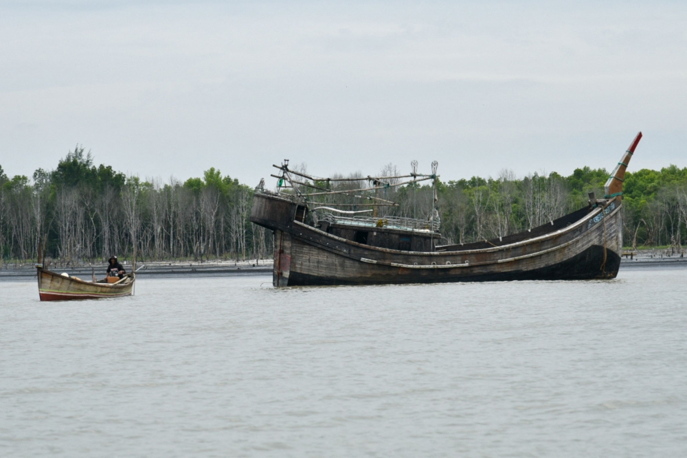 A wooden boat that carried Rohingya Muslims floats off the coast of Karang Gading village, Deli Serdang, North Sumatra province, Indonesia, January 1, 2024, in this photo taken by Antara Foto. — Antara Foto/Fransisco Carolio via Reuters pic