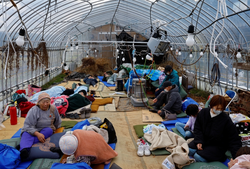 Evacuated people rest at a green house converted as an evacuation center, in the aftermath of an earthquake,  in Wajima, Ishikawa prefecture, Japan January 2, 2024. — Reuters pic