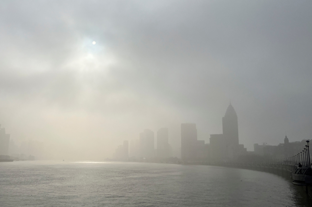 Buildings along the Huangpu river are seen shrouded in fog, amid a red alert for heavy fog in Shanghai, China December 29, 2023. — Reuters pic