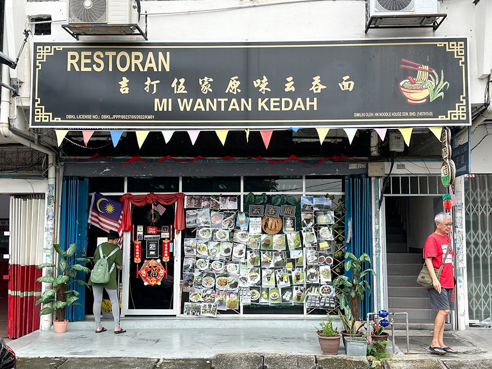 The front of the eatery draws customers in with their unusual blacked out windows and the collage of menu dishes.