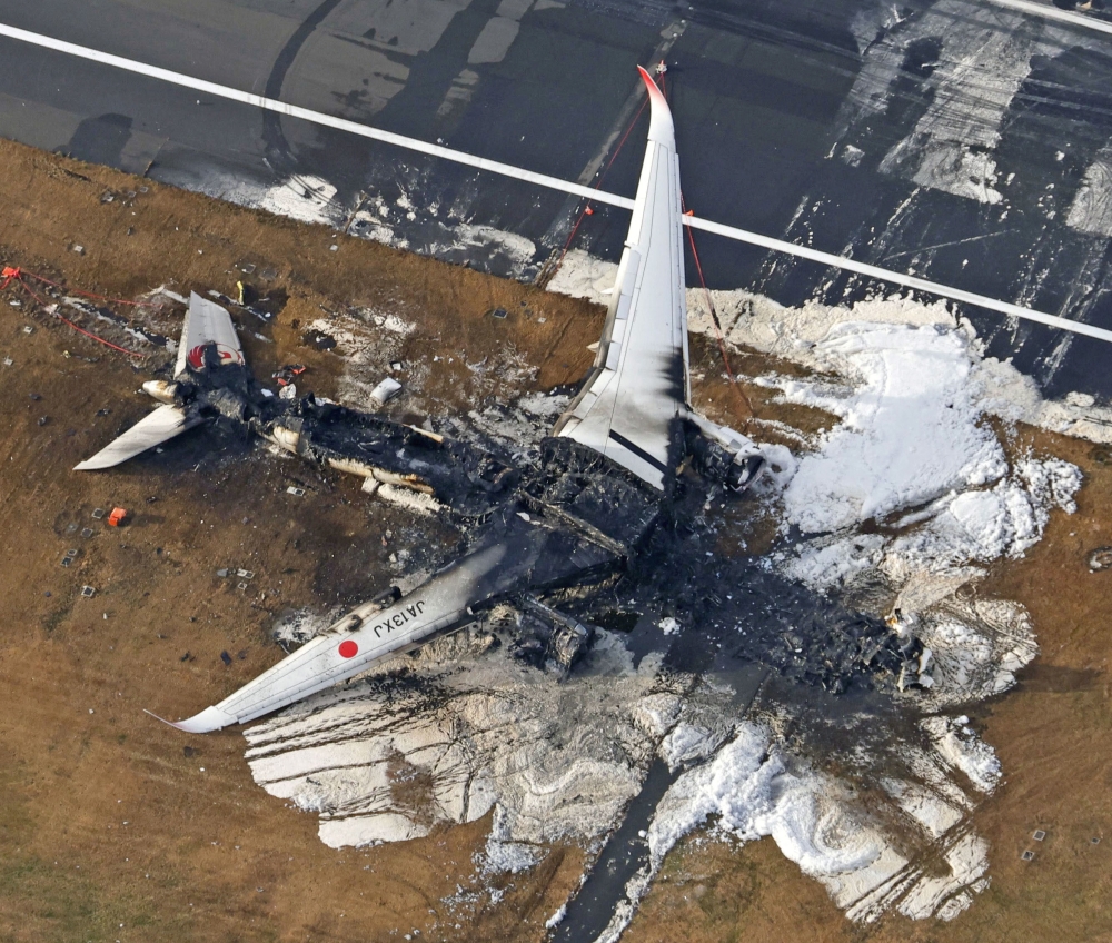 An aerial view shows burnt Japan Airlines' (JAL) Airbus A350 plane after a collision with a Japan Coast Guard aircraft at Haneda International Airport in Tokyo, Japan January 3, 2024, in this photo taken by Kyodo. ― Kyodo/via Reuters